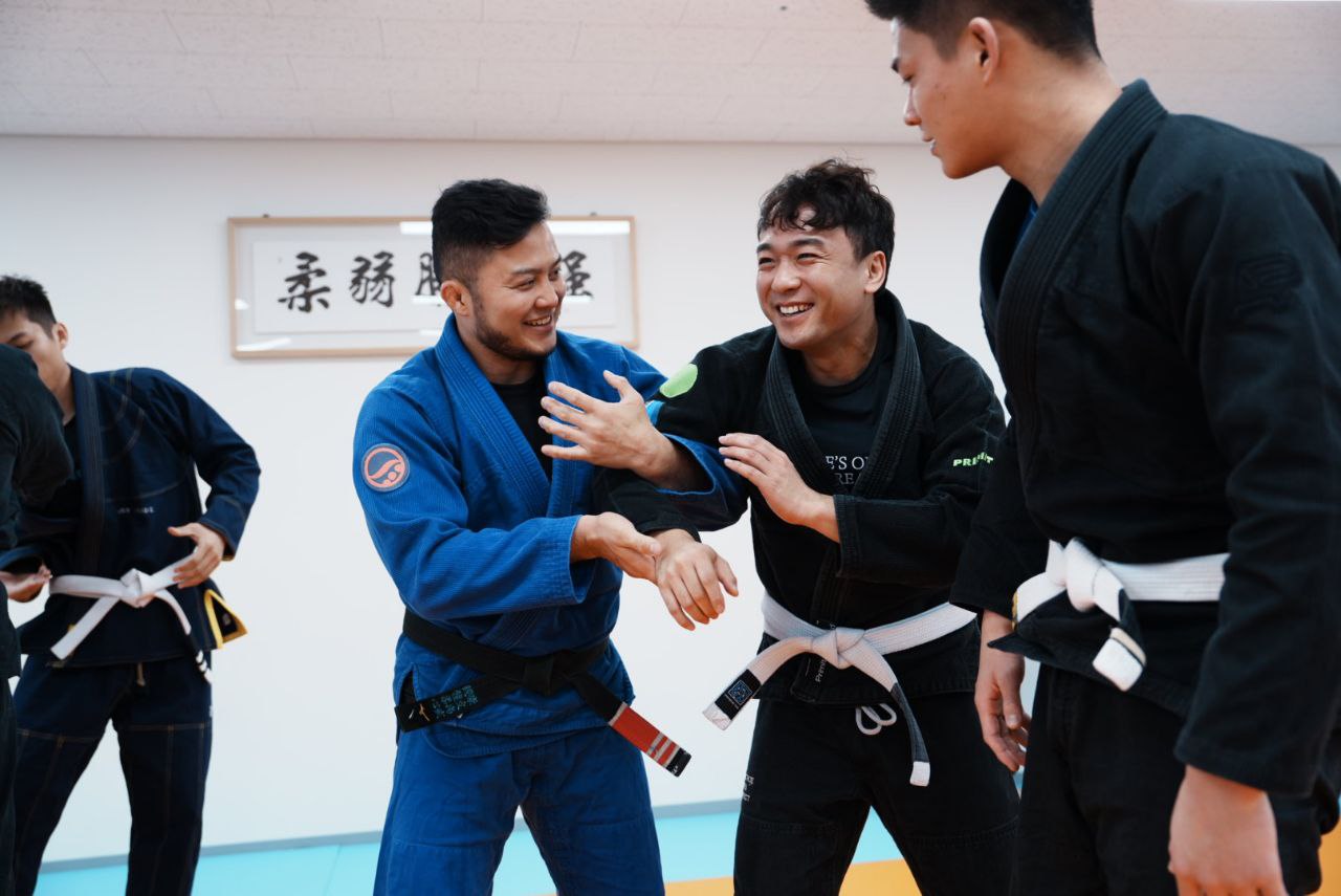 Two masked individuals, one armed with a pistol and flashlight, and one holding a gun, are cornered on a staircase. The pe...